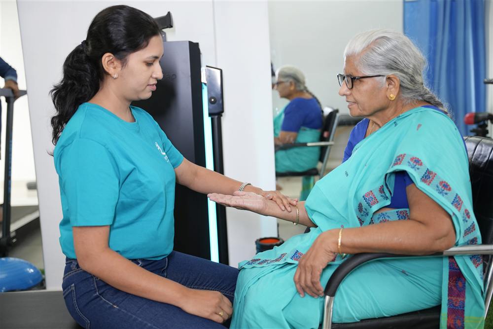 PhysioShine therapist working with a patient on arm mobility during cancer rehabilitation